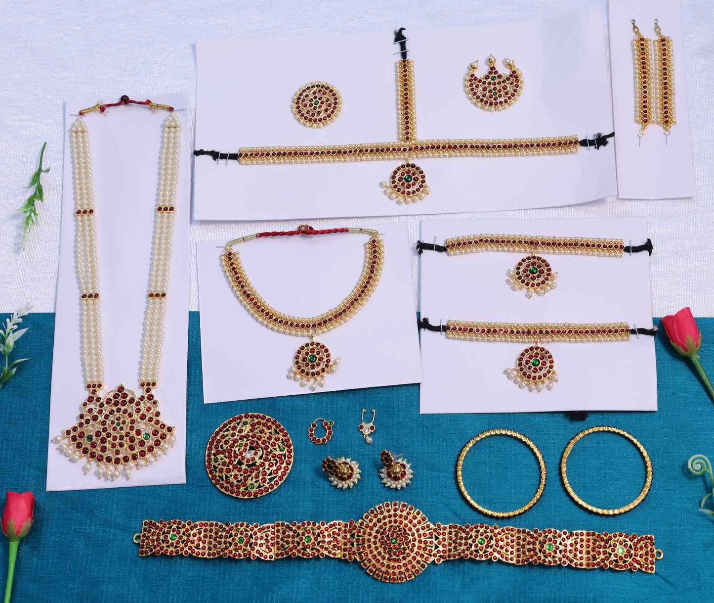 Bharatanatyam dance accessories set with Kemp stones, including earrings, necklace, and hair ornaments, crafted in traditional South Indian style.