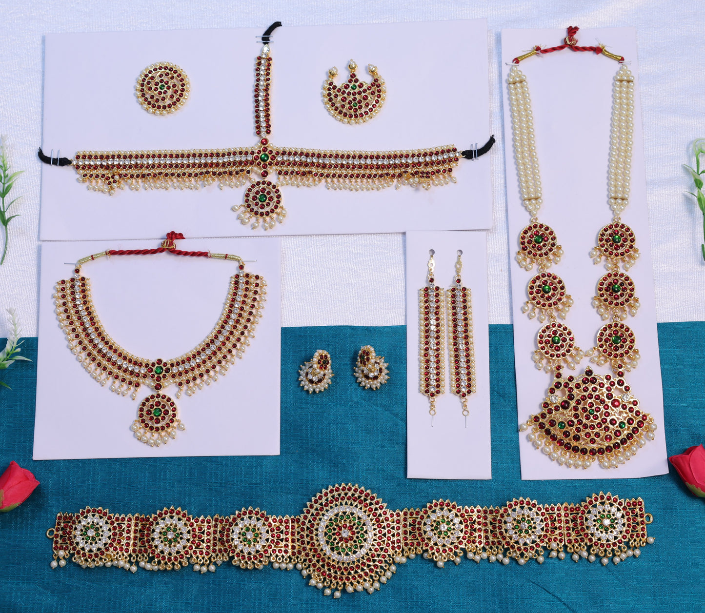 Bharatanatyam and Kuchipudi dance jewellery set featuring Kemp stone haram, necklace, earrings, waist belt and head ornaments arranged for arangetram performance