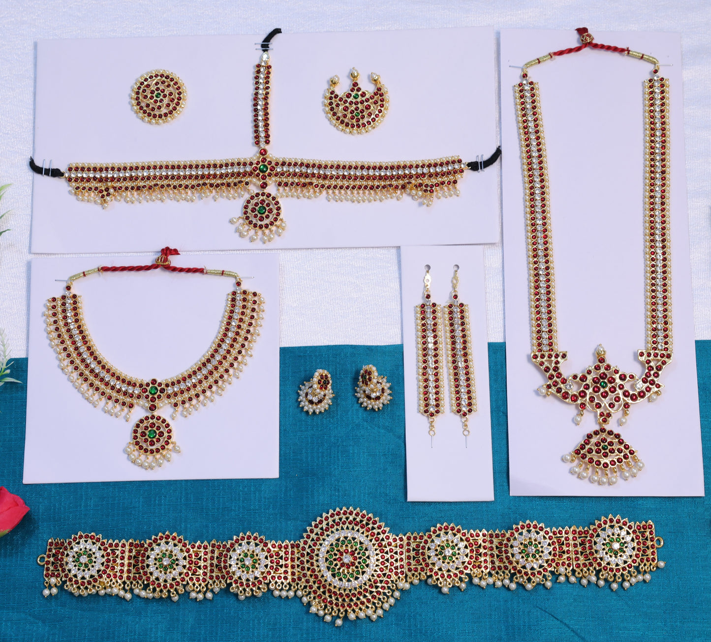 Complete Bharatanatyam temple jewellery set with long haram, choker, oddiyanam waist belt, jhumkas, mattal and head accessories in Kemp stone design for classical dance performances