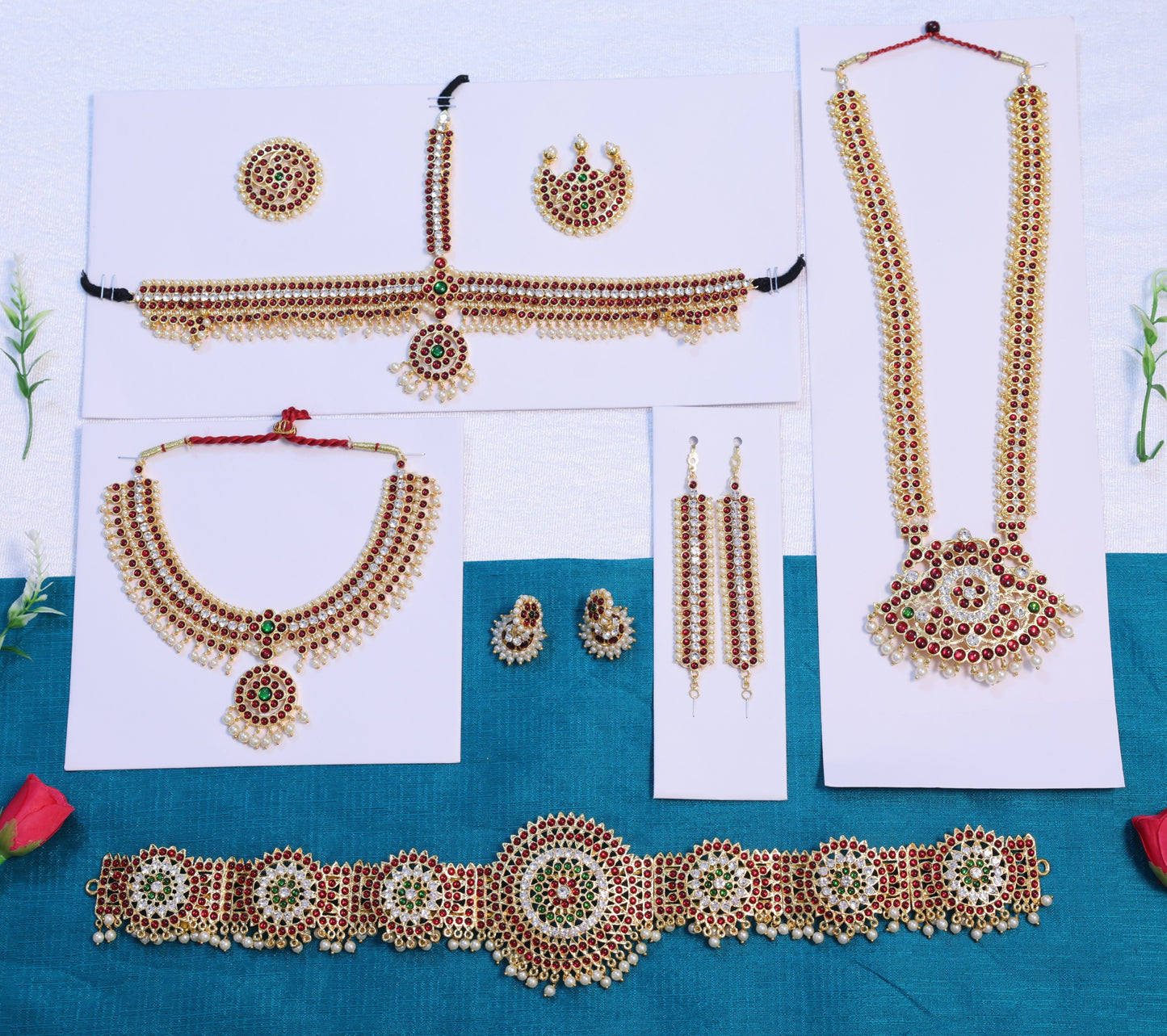 Complete Bharatanatyam temple jewellery set with long haram, choker, oddiyanam waist belt, jhumkas, mattal and head accessories, crafted with red-green Kemp stones for classical dance