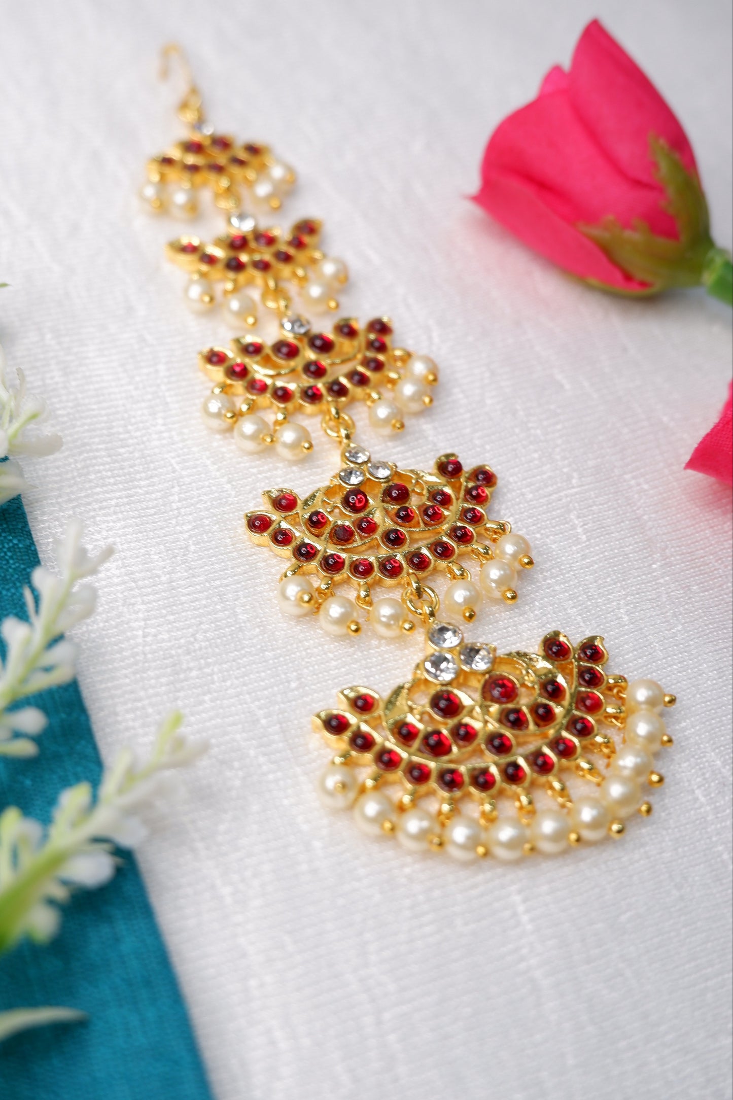 Vibrant kemp stone work on classical dance nethi chutti