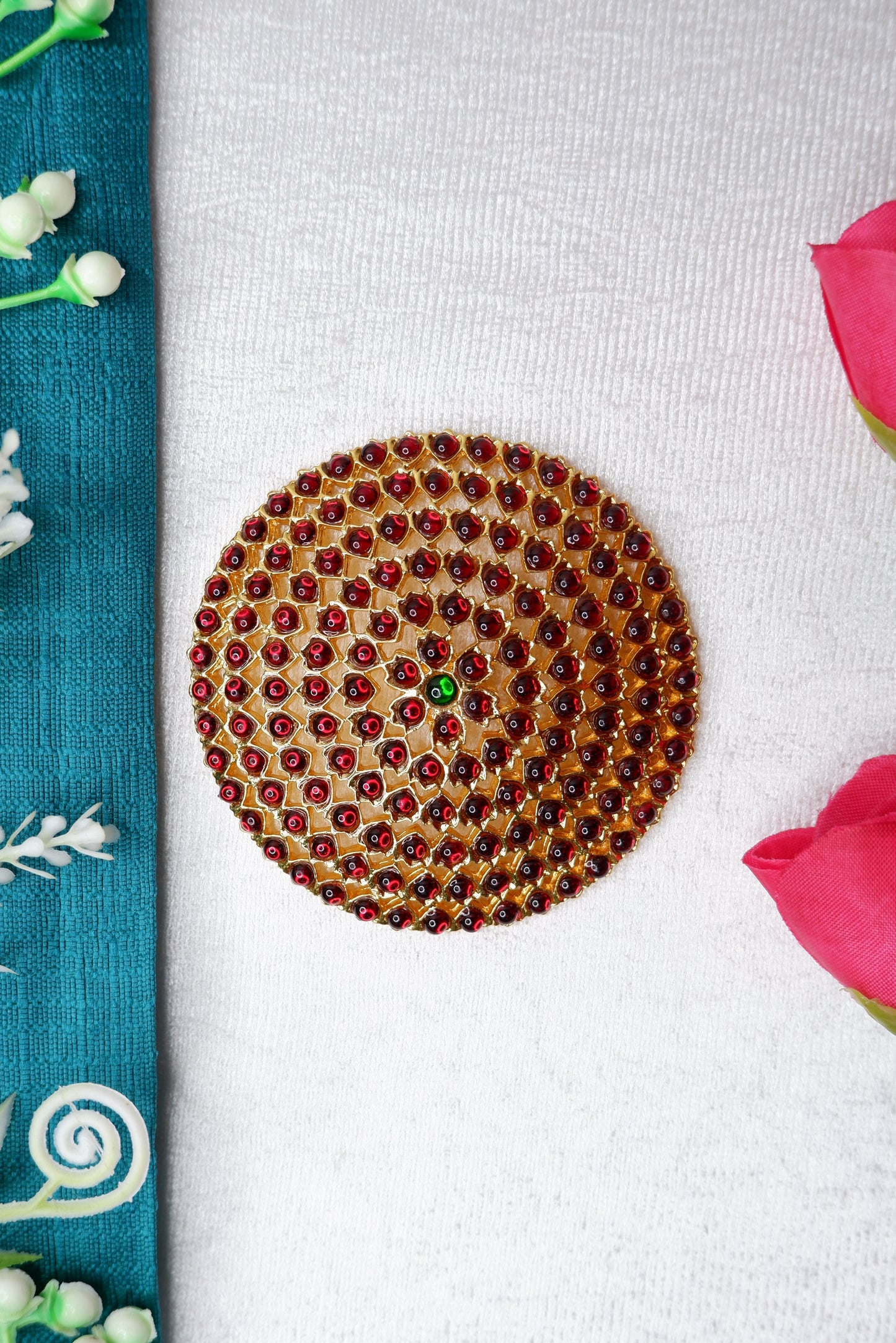 Ornate ragaadi rakodi hair accessory adorning a Bharatanatyam and Kuchipudi dancer's braided bun, featuring temple jewelry design and gemstones.