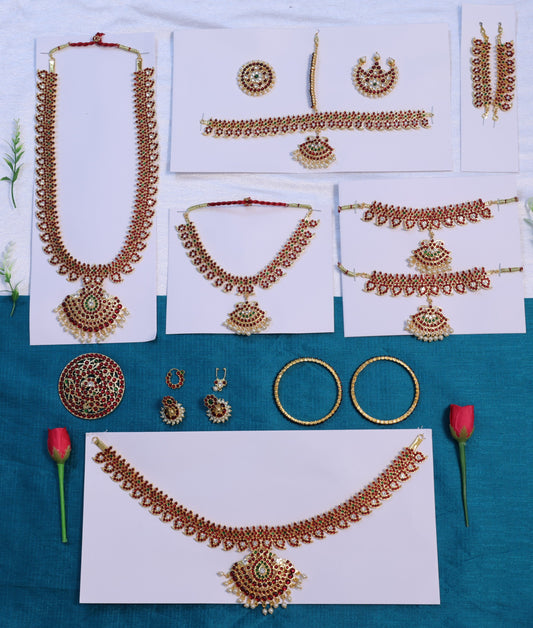 Mango design Bharatanatyam temple jewellery full set with kemp stones, including haram, choker, vanki, belt, bangles, earrings and rakodi displayed on blue background.