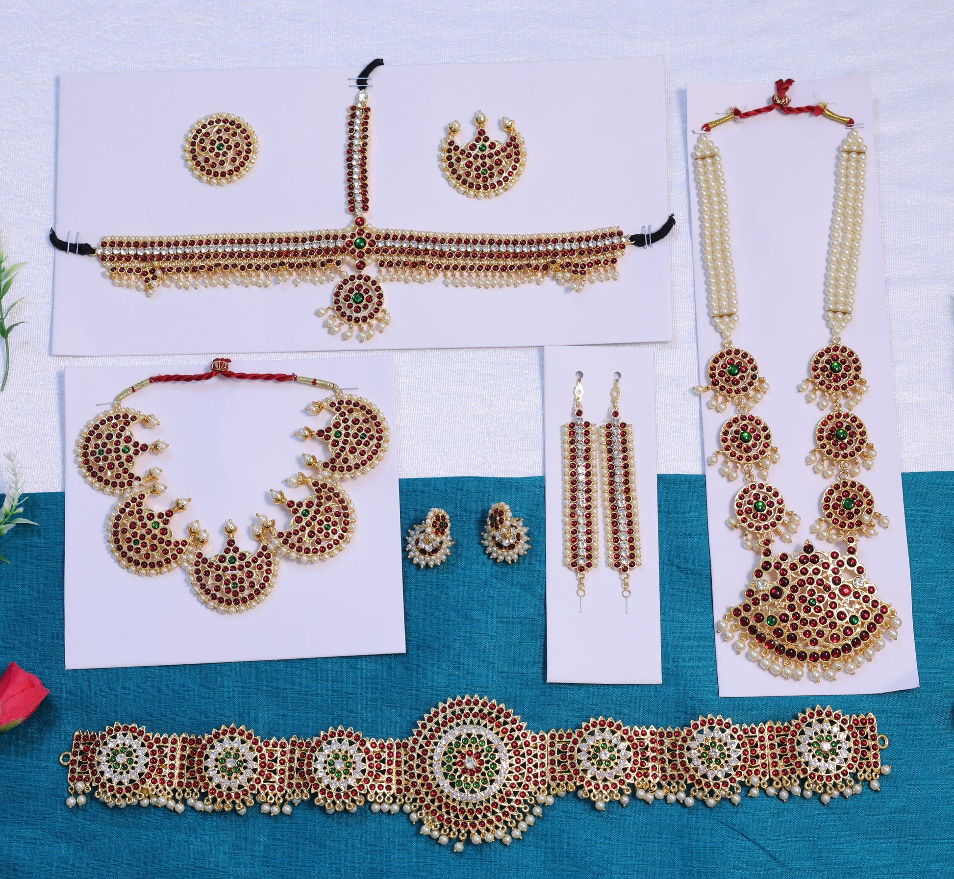 Premium Bharatanatyam and Kuchipudi temple jewellery set with long haram, crescent choker, oddiyanam waist belt, jhumkas, mattal and headpieces crafted with Kemp stones and pearls