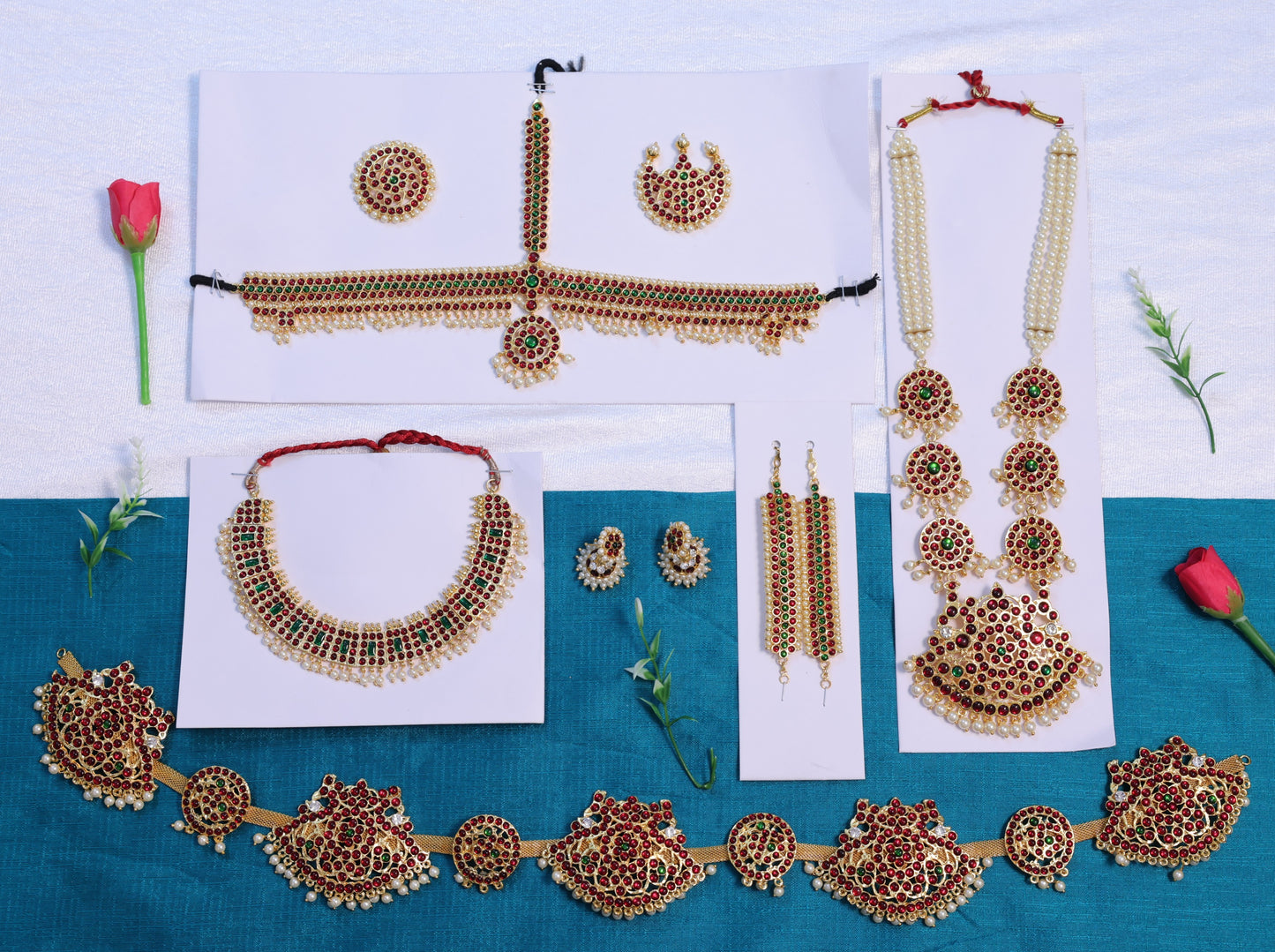 Premium Bharatanatyam temple jewellery set with long haram, choker, oddiyanam, jhumkas and head ornaments in Kemp stones, available with fast USA shipping.
