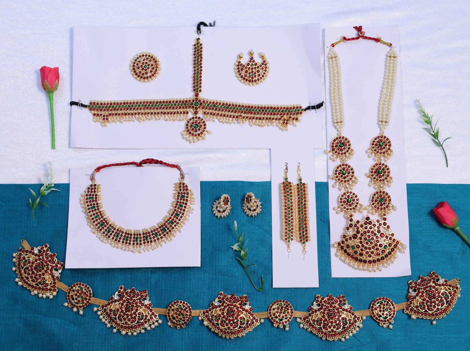 Premium Bharatanatyam temple jewellery set with long haram, choker, oddiyanam, jhumkas and head ornaments in Kemp stones, available with fast USA shipping.