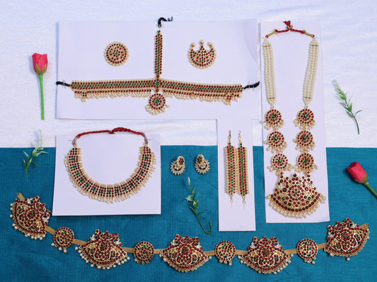 Premium Bharatanatyam temple jewellery set with long haram, choker, oddiyanam, jhumkas and head ornaments in Kemp stones, available with fast USA shipping.