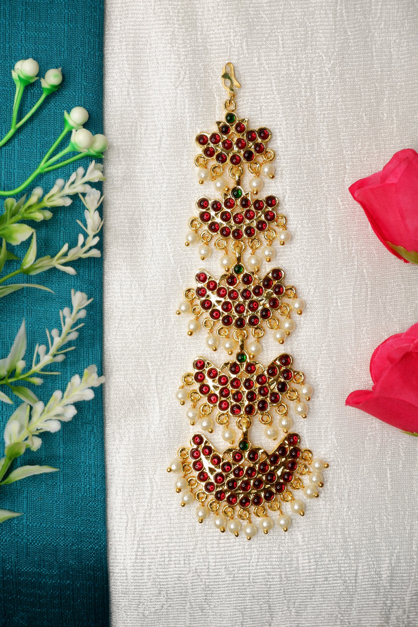 raditional Bharatanatyam dancer wearing ornate gold mang tika with temple jewelry set.
