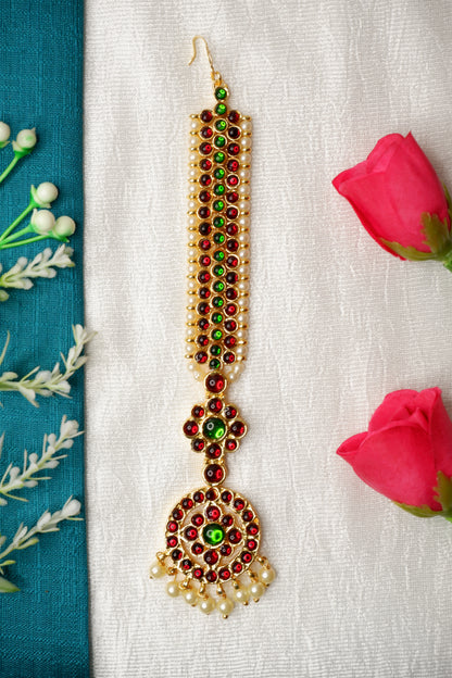 Traditional South Indian dancer with decorative nethi chutti jewelry and expressive makeup