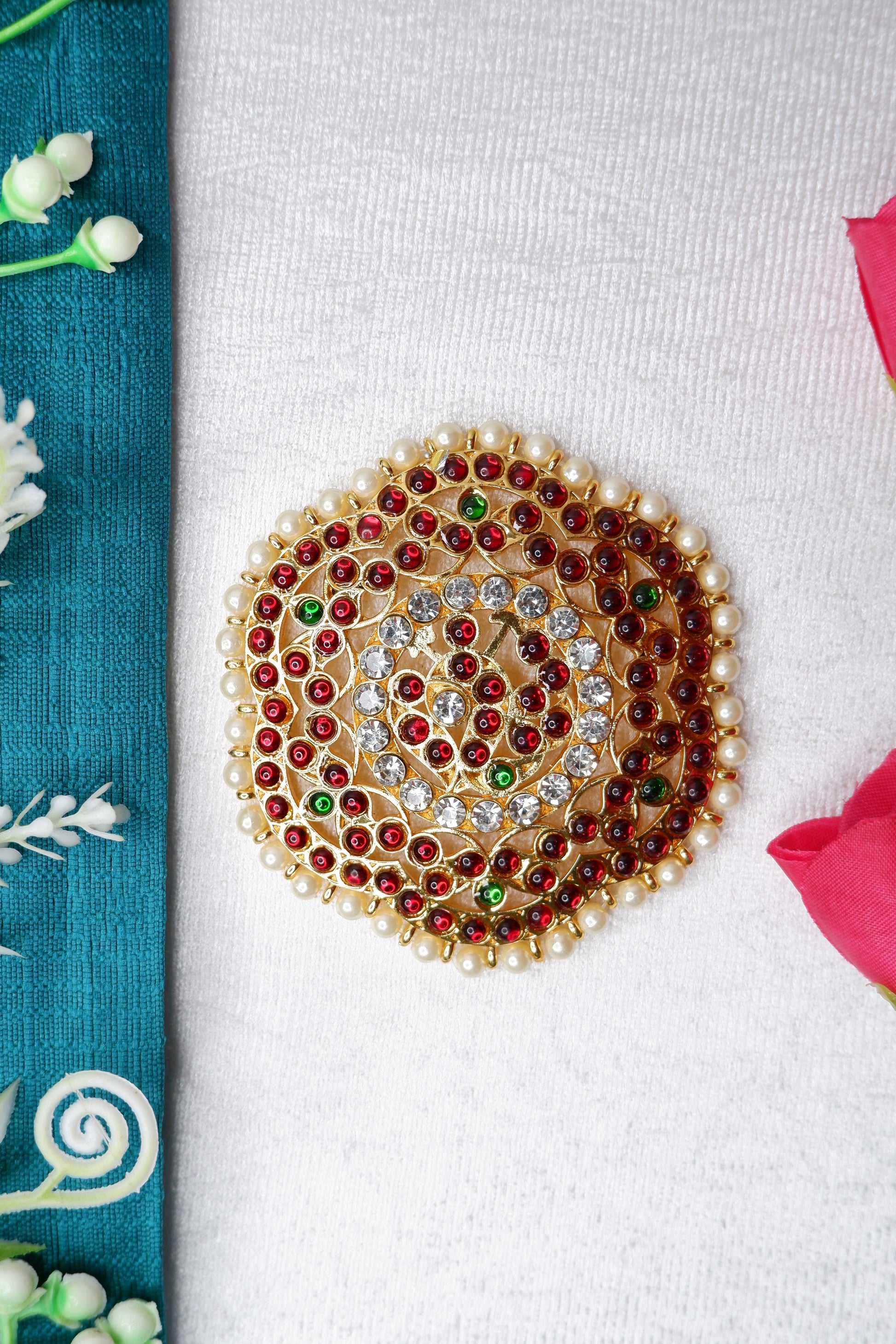 Bharatanatyam dancer wearing a gold rakodi hair accessory with classical temple jewelry.