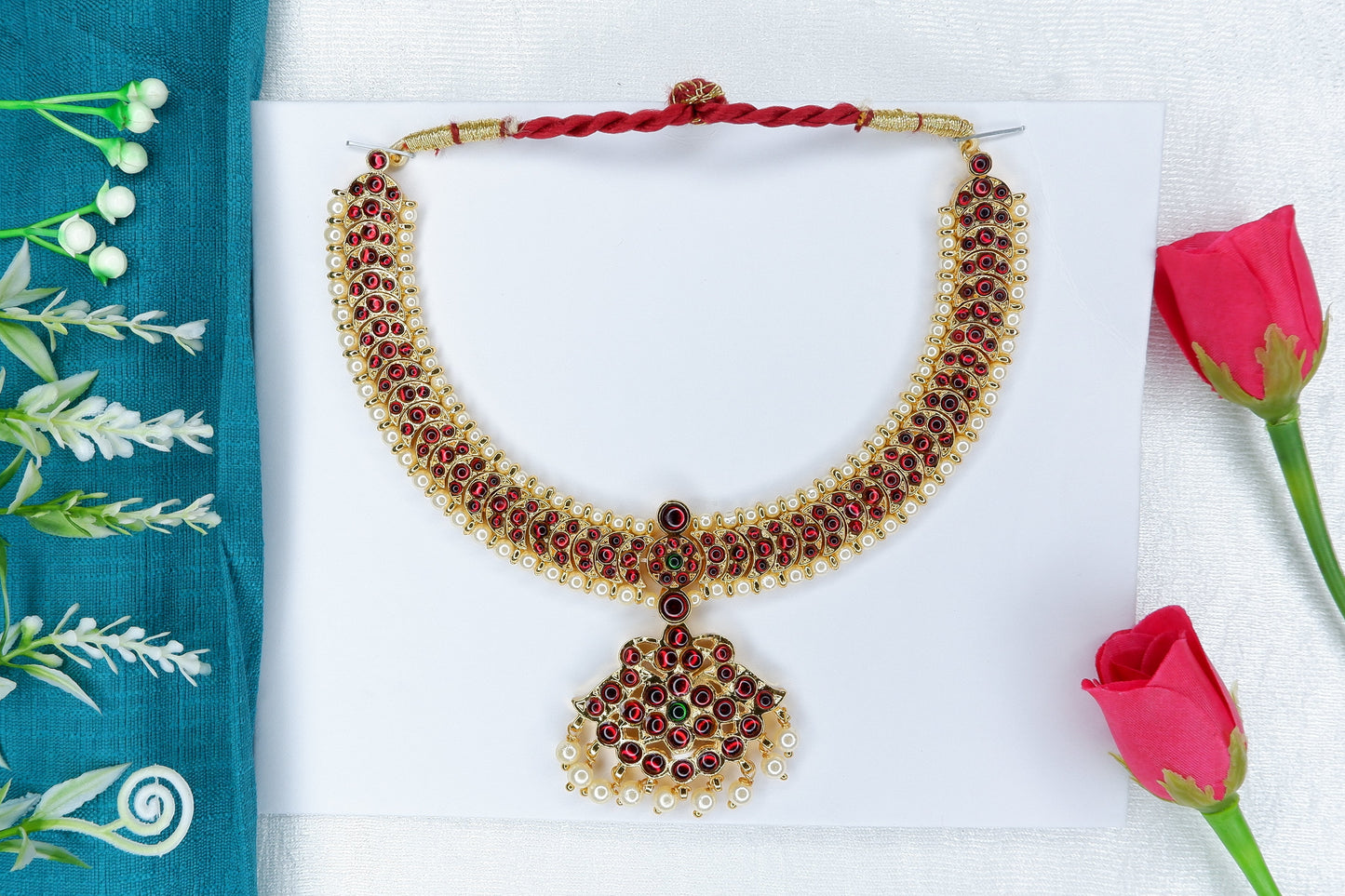Bharatanatyam/Kuchipudi short neckpiece decorated with red and green stones in a temple-jewellery style.