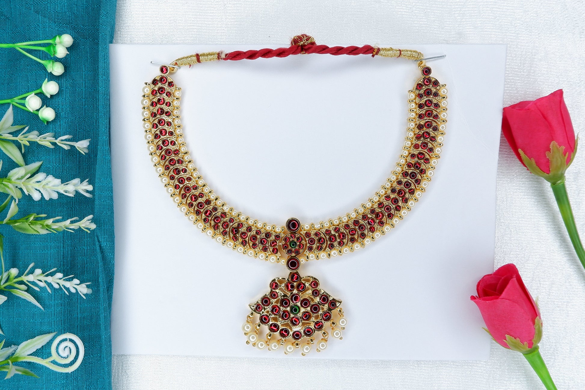 Bharatanatyam/Kuchipudi short neckpiece decorated with red and green stones in a temple-jewellery style.