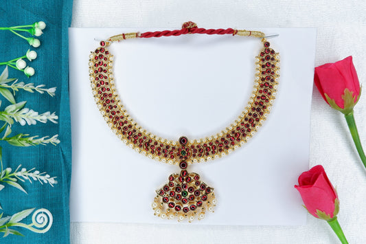 Bharatanatyam/Kuchipudi short neckpiece decorated with red and green stones in a temple-jewellery style.